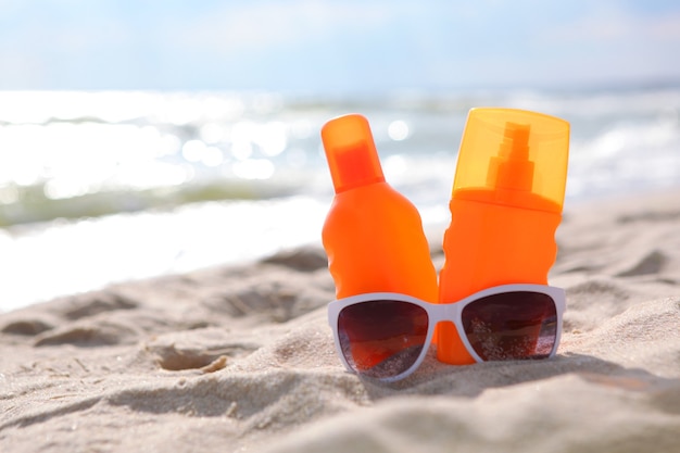 Premium Photo | Sunscreens on the beach near the sea close up