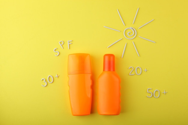 Premium Photo | Sunscreens on a colored background top view