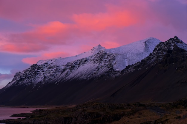 Premium Photo | Sunset colors on winter ice at the vestrahorn mountain ...