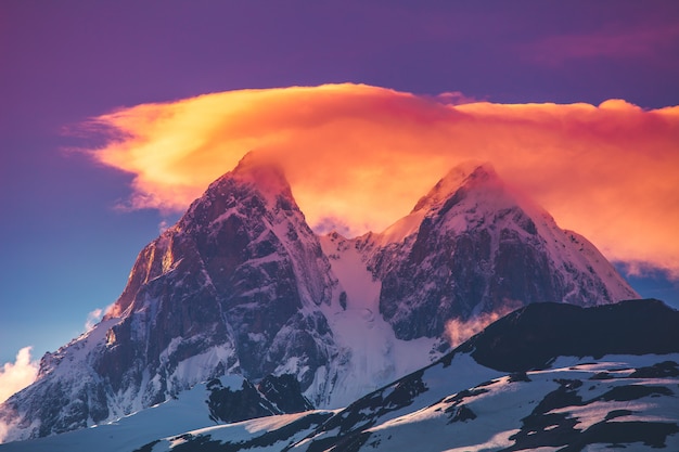 Premium Photo | Sunset evening view over the snowy mountain range