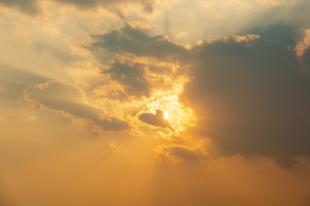 Premium Photo | Sunset sunlight through clouds background.