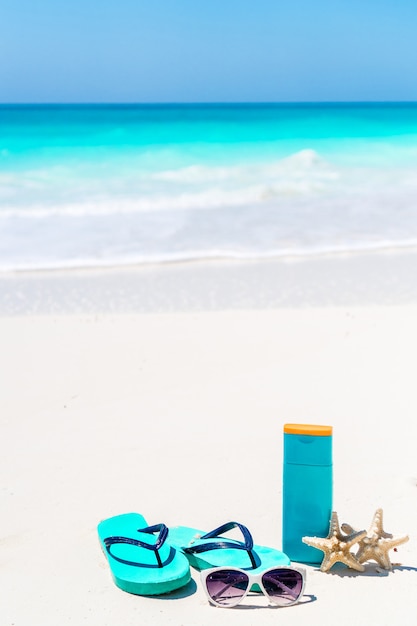 Premium Photo Suntan Lotion Bottles And Starfish At The Beach