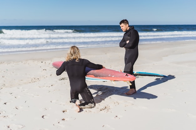 Premium Photo | Surf instructor with a student on the ocean. surfer in ...