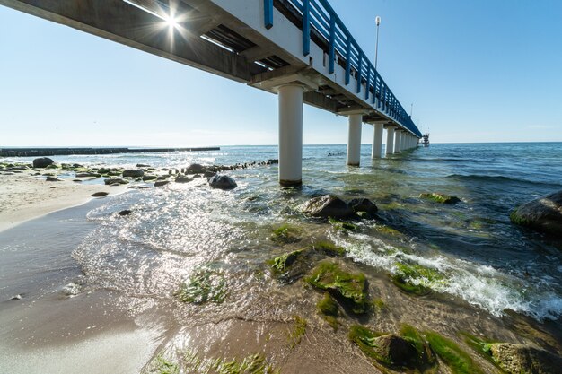 Surf waves with sea foam and seaweed on tourist beach Premium Photo