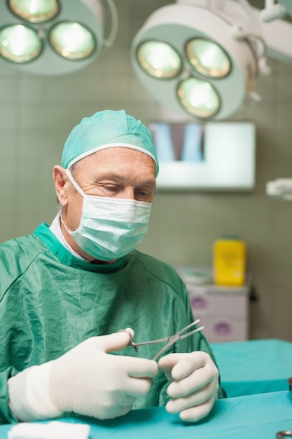 Premium Photo | Surgeon holding scissors