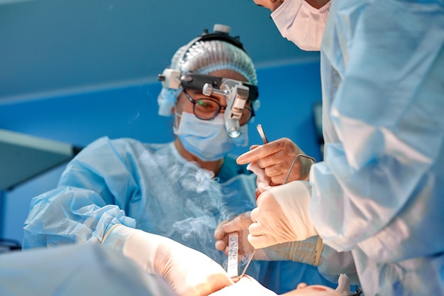 surgeon-performing-cosmetic-surgery-hospital-operating-room-surgeon-mask-wearing-loupes-during-medical-procadure-breast-augmentation_124865-3727.jpg (626×417)
