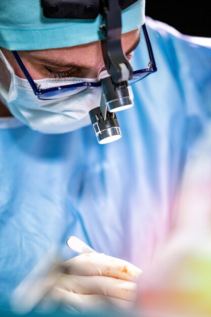 Premium Photo | Surgeon performing surgery in hospital operating room ...