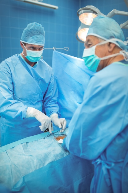 Premium Photo | Surgeon with scalpel performing operation in operation ...