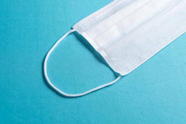 Free Photo | Surgical mask over minimalist blue background