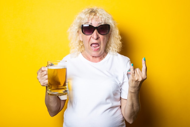 Kalksteen Antipoison methodologie Premium Photo | Surprised blonde old woman holding a glass of beer and  showing a rocker goat