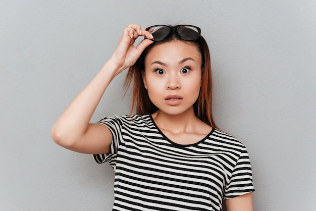 Premium Photo Surprised Woman Taking Off Her Glasses