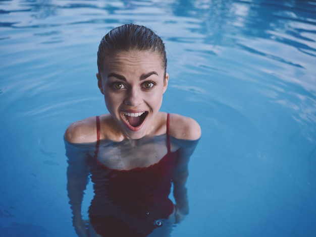 Premium Photo | Surprised woman with open mouth in the pool red ...