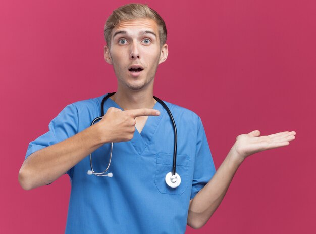 Free Photo Surprised Young Male Doctor Wearing Doctor Uniform With Stethoscope Pretending 8617