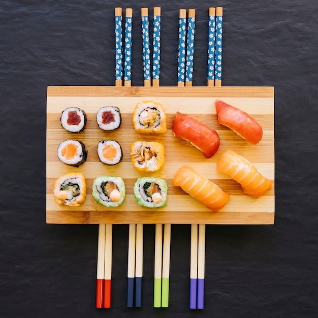 Sushi on chopsticks | Free Photo