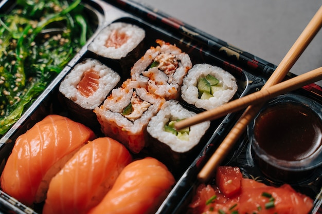 Premium Photo Sushi To Go Concept Collection Box With Sushi With Sushi Rolls And Chopsticks Maki Sashimi Salmon Tuna Wasabi Asian Japanese