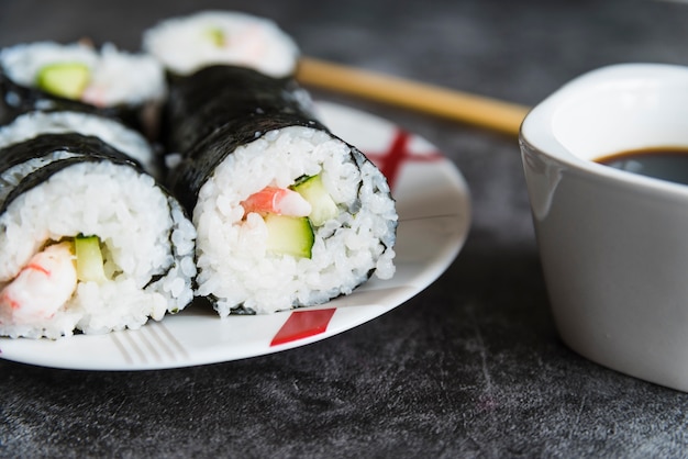 Free Photo | Sushi rolls, soy sauce and chopsticks