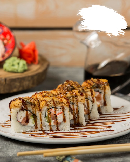 Free Photo | Sushi rolls with soy sauce inside white plate.