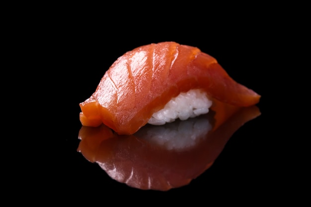 Sushi salmon over black Premium Photo