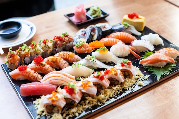 Premium Photo | Sushi set on the black plate japanese food in resturant