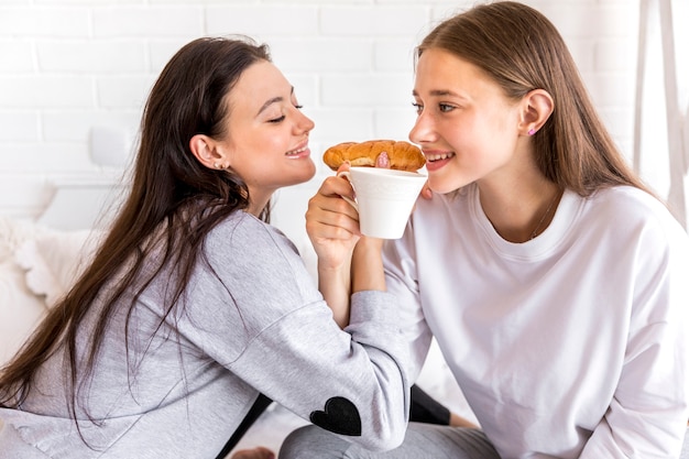 Free Photo  Sweet Lesbian Couple Eating Breakfast