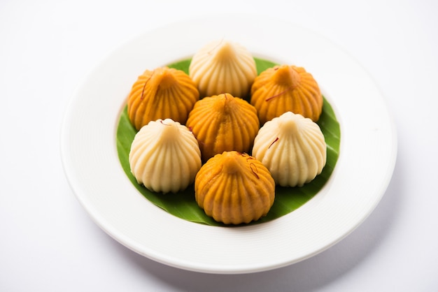 Premium Photo | Sweet modak food offered while ganapati pooja or ganesh ...