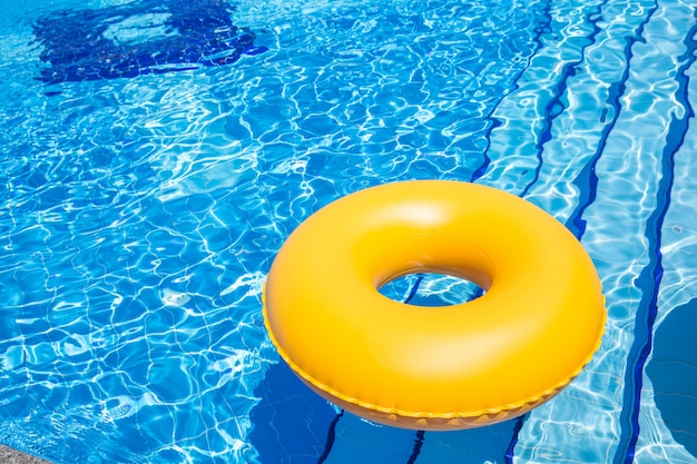 Premium Photo | Swimming pool yellow inner tube i pool