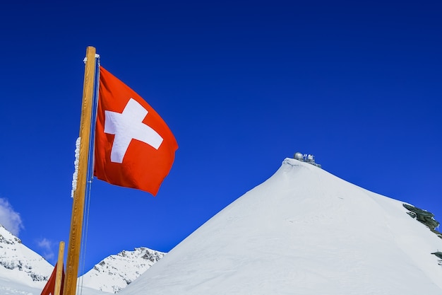 Premium Photo | Switzerland flag and sphinx observatory at top of ...