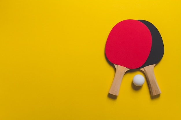 table tennis rackets on yellow surface_23 2147601760