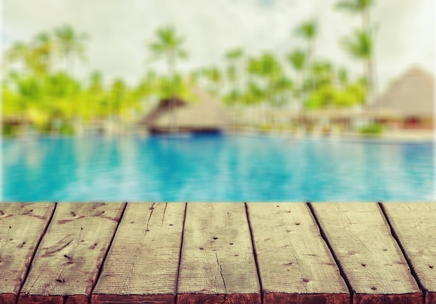 Premium Photo | Table top and blur swimming pool of the background