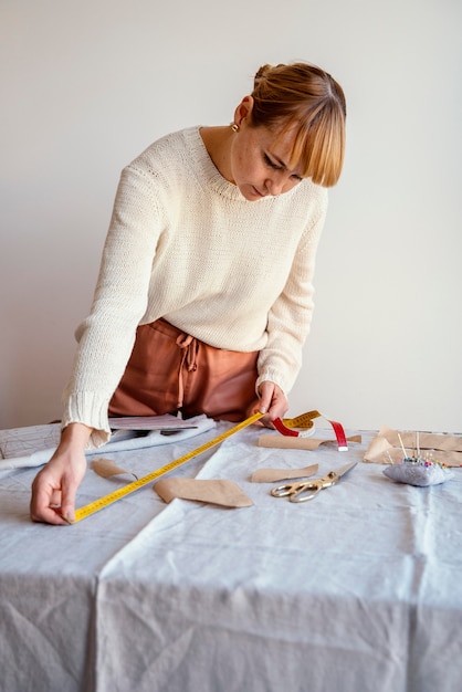 Free Photo | Tailor woman using ruler to measure the fabric