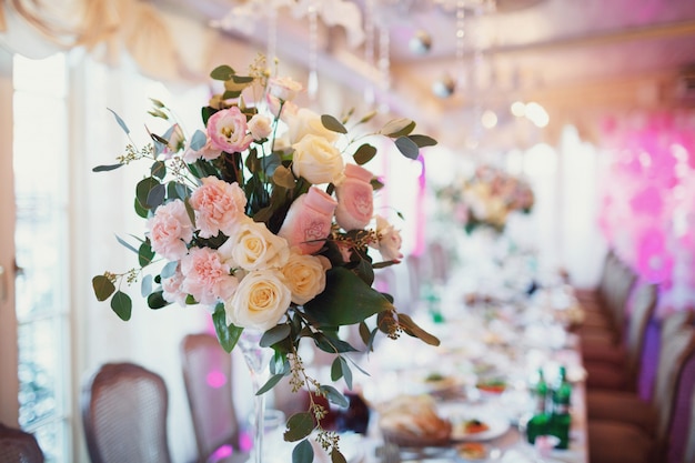 Tall Vases With Pink Flowers Stand On Long Dinner Table Photo