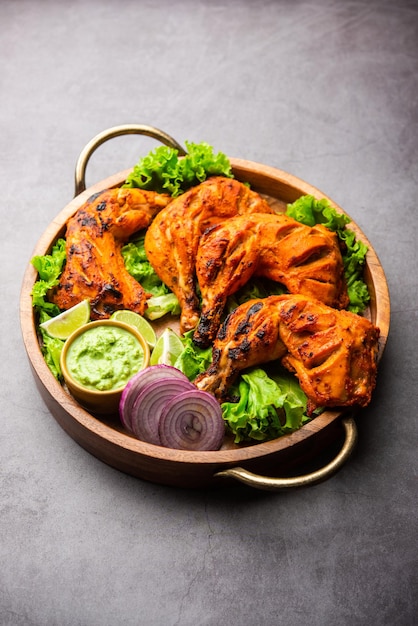 Premium Photo | Tandoori chicken is a chicken dish prepared by roasting ...