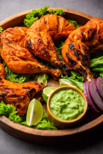 Premium Photo | Tandoori chicken is a chicken dish prepared by roasting ...