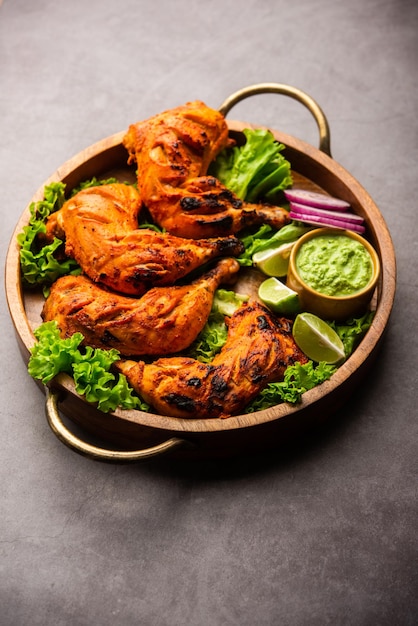 Premium Photo | Tandoori chicken is a chicken dish prepared by roasting ...