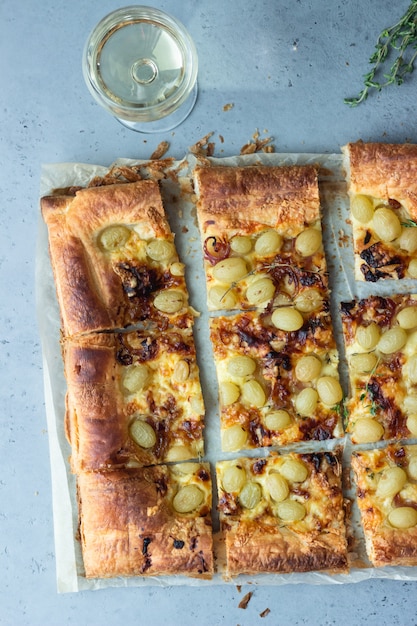 Premium Photo | Tart made with puff pastry, caramelized onion, cheese ...