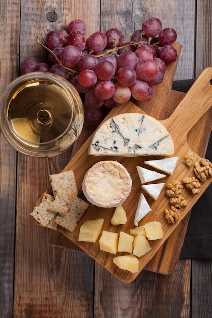 Premium Photo | Tasting cheese dish on a wooden background.