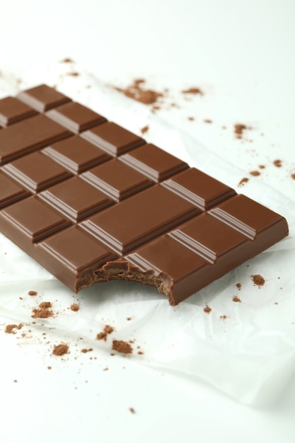 Premium Photo | Tasty chocolate bar on paper on white