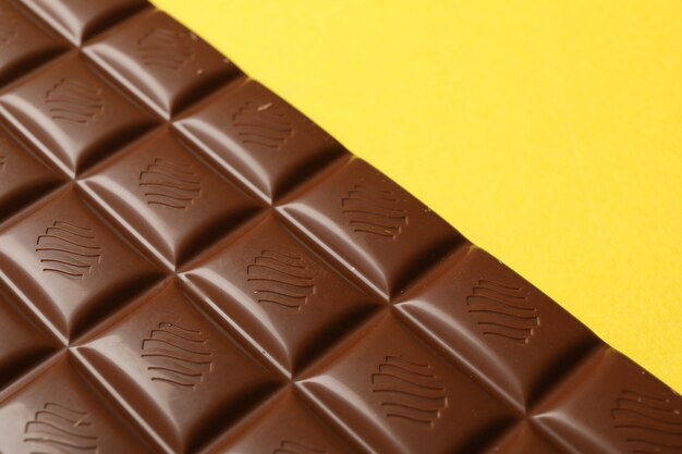 Premium Photo | Tasty chocolate bar on yellow background