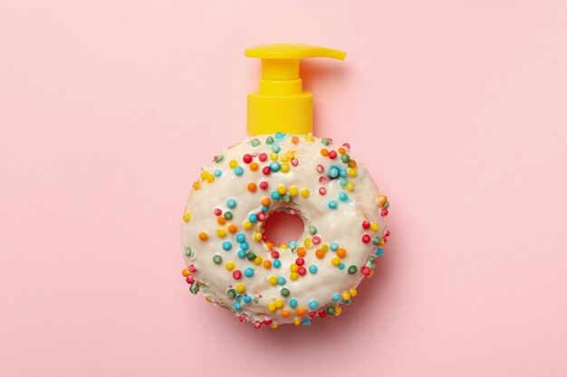 Download Premium Photo Tasty Donut With Dispenser On Pink Background