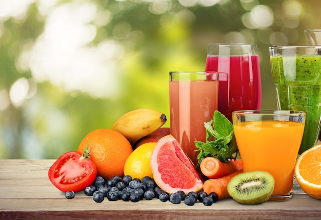 Premium Photo | Tasty fruits and juice with vitamins on background