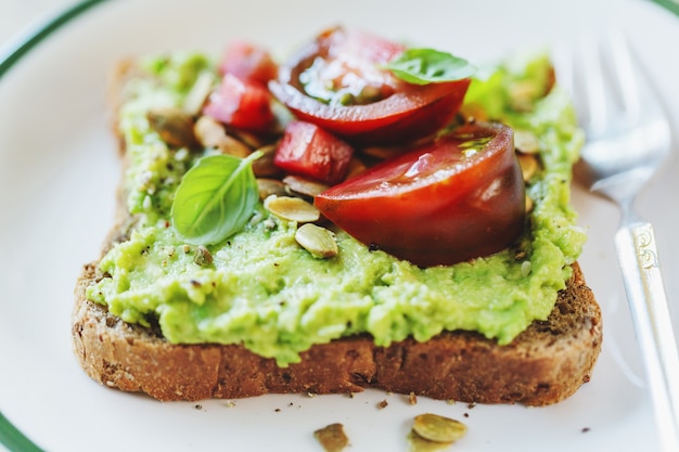 Premium Photo | Tasty sandwich on wholegrain bread with mashed avocado ...