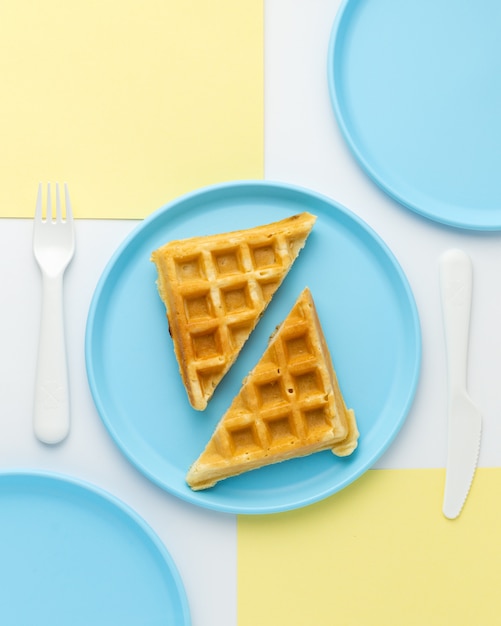 Tasty waffle on childish blue plate, top view Free Photo