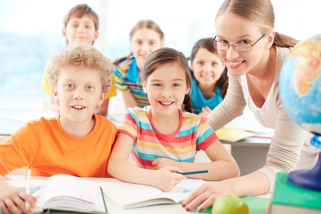 Teacher and students smiling in class Photo | Free Download