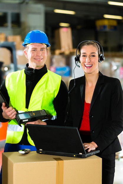 Teamwork Warehouseman Or Forklift Driver And Female Supervisor With Laptop Headset And Cell Phone At Warehouse Of Freight Forwarding Company A Forklift Premium Photo