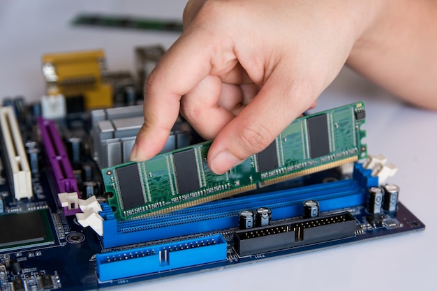 Premium Photo | Technician installing ram stick (random access memory