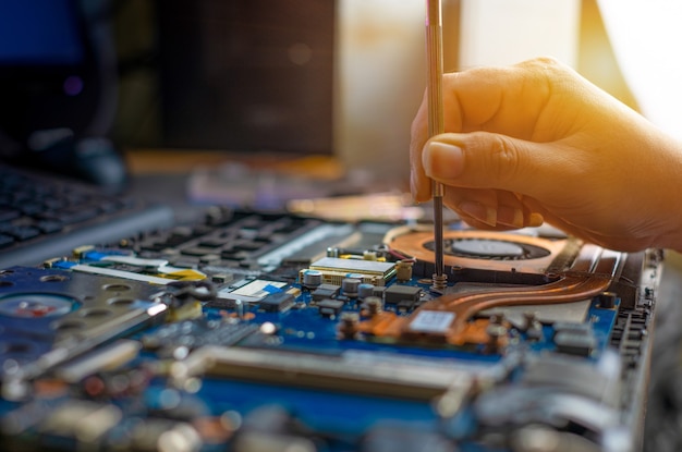 Premium Photo | Technician Repairing Broken Laptop Notebook Computer ...