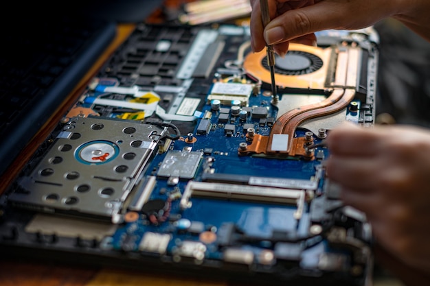 Premium Photo Technician Repairing Broken Laptop Notebook Computer