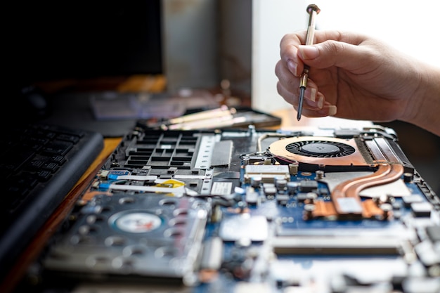 Premium Photo | Technician Repairing Broken Laptop Notebook Computer ...