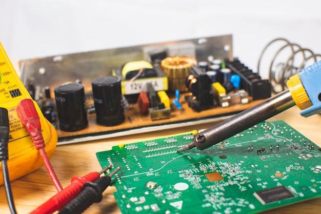 Premium Photo | Technician using an electric soldering iron