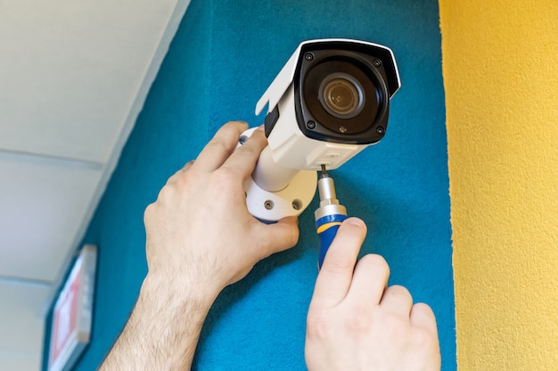 Premium Photo | Technician worker installing video cctv camera